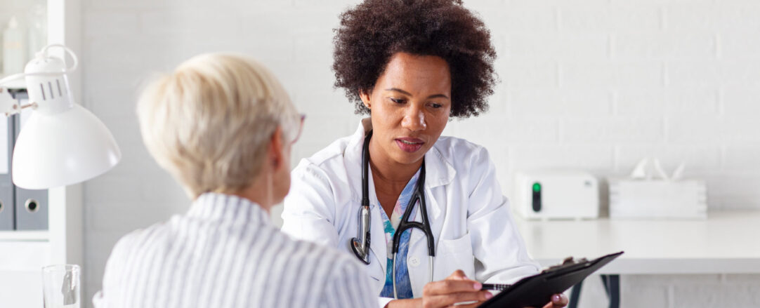 Mature woman with her doctor in ambulance talking about healthca Mature woman with her doctor in ambulance talking about healthcare